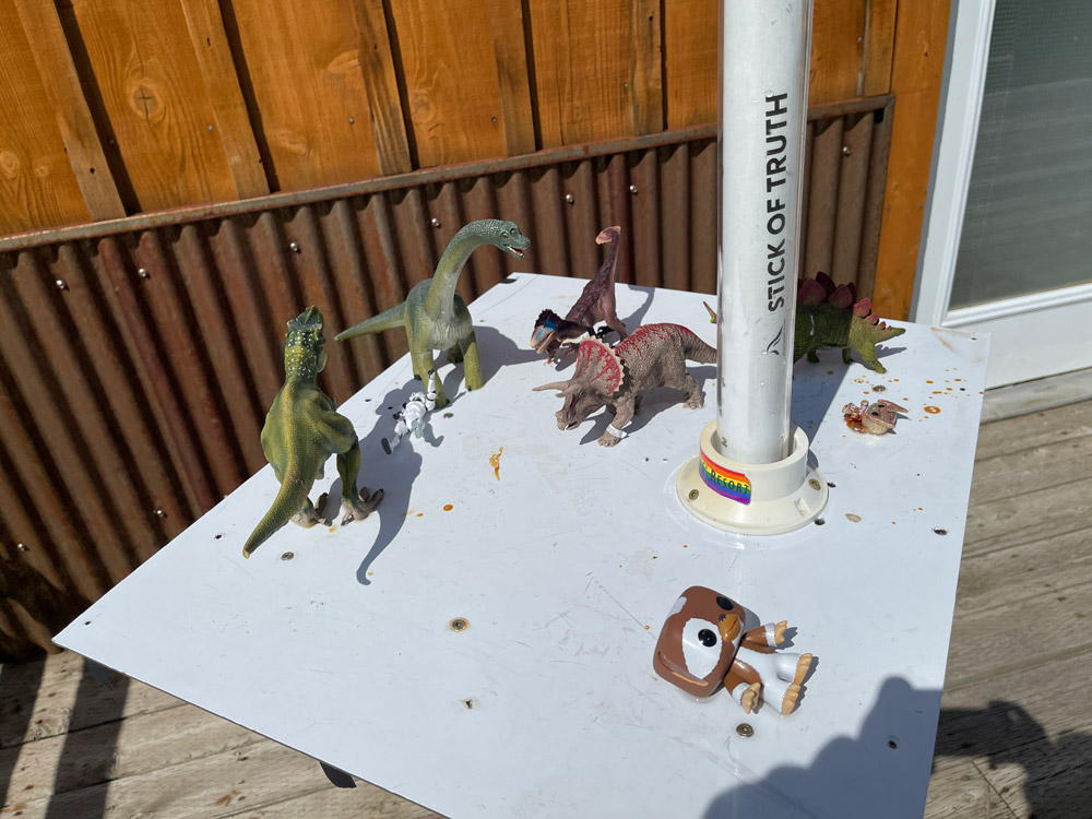 Dinosaur toys on a small white table.