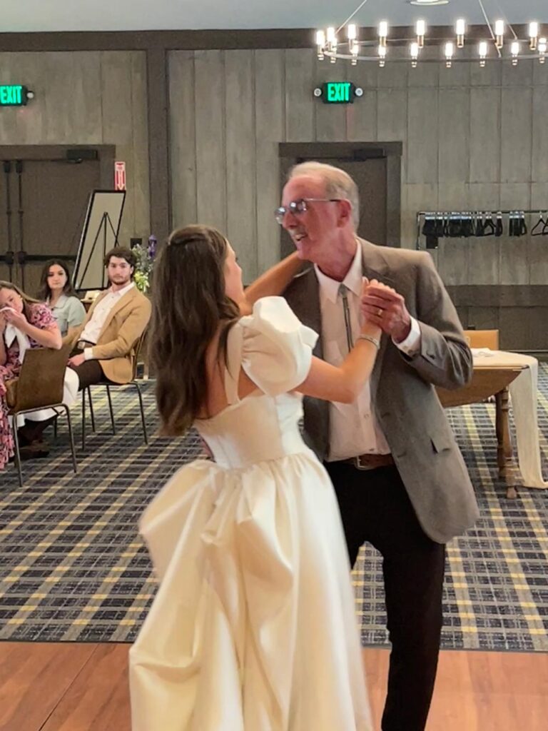 Kristen and her father dancing.